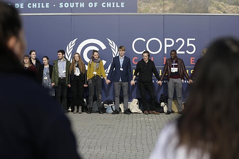 Young activists from the 'Fridays For Future' climate protest Movement form a human chain at the COP25 Climate summit in Madrid, Spain. (Photo | AP)