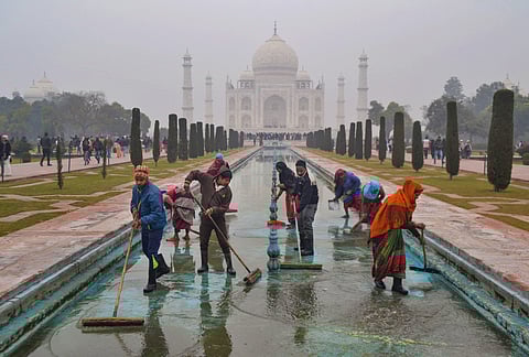 Workers clean the fountain at Taj Mahal in Agra. (Photo| PTI)