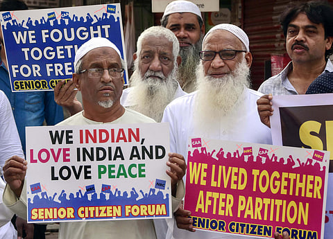 Members of Muslim community hold placards during a protest against the Citizenship Amendment Act CAA and NRC at Agripada in Mumbai Friday Dec. 20 2019. (Photo | PTI)