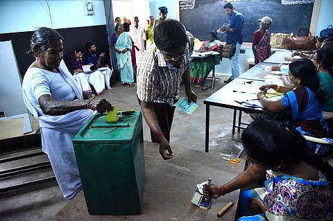 People seen casting their vote through ballot sealing method for panchayat president post at Panchayat union school at kinathukadavu near Pollachi on Friday. (Photo | EPS/A. Raja Chidambaram)