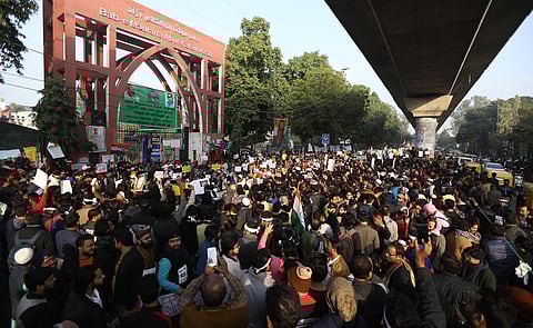 Protestors including students and local residents during a demonstration against the Citizenship Amendment Act CAA outside Jamia Millia Islamia University in New Delhi. (File | EPS)