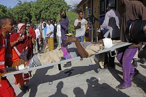 Medical personnel carry a civilian who was wounded in suicide car bomb attack. (Photo| AP)