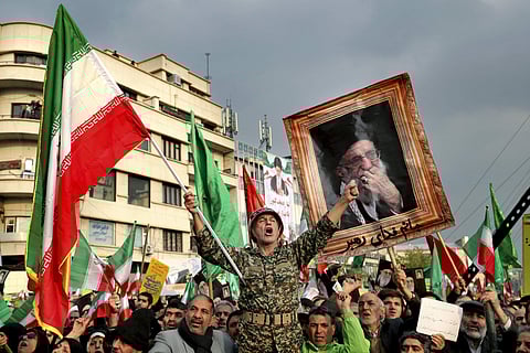 In a Nov. 25, 2019, file photo, a demonstrator chants slogans while holding up an Iranian national flag during a pro-government rally in Tehran, Iran, denouncing violent protests over a government-imposed fuel price hike. (Photo | AP)