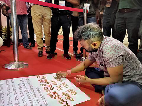 Mariani MLA Rupjyoti Kurmi sitting on the Assam Assembly floor to write anti-government messages. (Photo | Express)