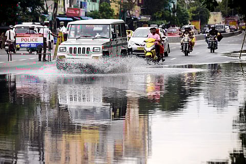 Commuters drive through waterlogged Kamarajar Promenade near All India Road in Chennai on Monday. (Photo | Debdatta Mullick/EPS)