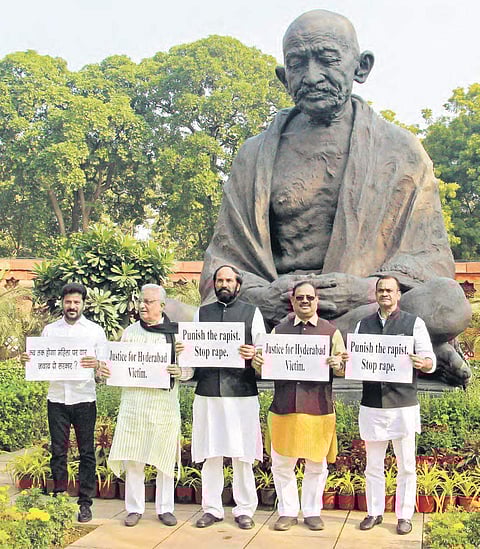 (From left) Malkajgiri MP A Revanth Reddy, Rajya Sabha MP MA Khan, Nalgonda MP Uttam Kumar Reddy, AICC Telangana in-charge RC Khuntia and Bhongir MP Komatireddy Venkat Reddy stage a dharna before Mahatma Gandhi’s statue on the Parliament premises seekin