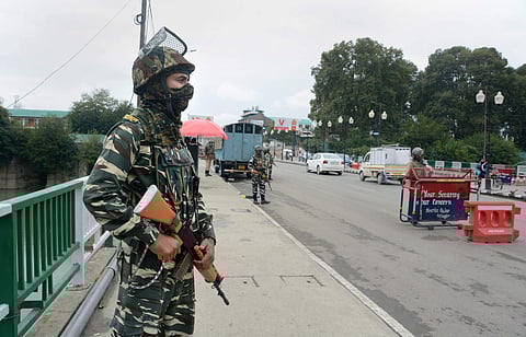 A heavily-equipped security personnel stand guard in Srinagar (File Photo | PTI)