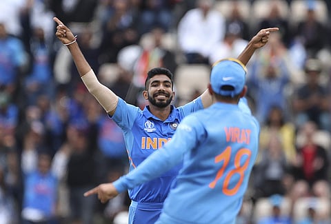 India's Jasprit Bumrah, left, celebrates with captain Virat Kohli. (Photo | AP)