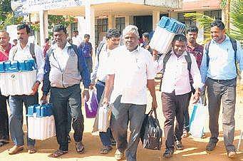 Staffers on election duty in Hunsur on Wednesday | Express
