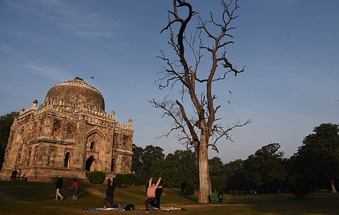 People out for a stroll and morning fitness routines on the lawns of Lodhi Garden on Wednesday. (Photo | Parveen Negi, EPS)