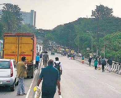 People on Hosur Main Road are now forced to squeeze through on the other side which has been kept open for vehicular movement | Express