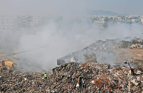A view of the smoke-engulfed Ajit Singh Nagar dump yard in Vijayawada on Thursday. (Photo | EPS)