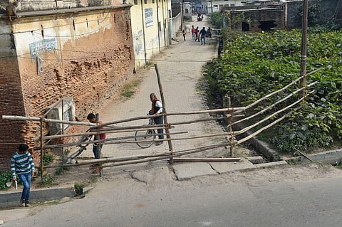 Cyclists attempt to cross a barricade set up as security measure on the eve of the 27th anniversary of the Babri Masjid demolition in Ayodhya Thursday Dec. 5 2019. (Photo | PTI)