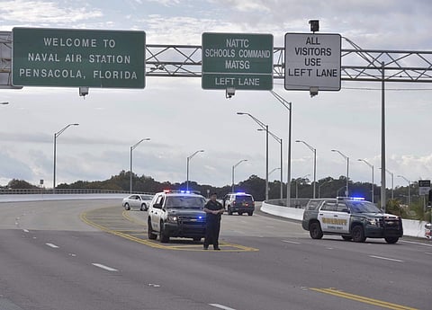 Police vehicles block the entrance to the Pensacola Air Base after the shooting. (Photo | AP)