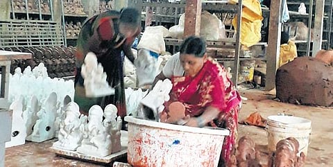Members of Kumbhar community work at a workshop in Konnur, Gokak, on Friday | express