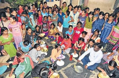 Guntur district collector I Samuel Anand Kumar eating with the inmates of Kasturba Gandhi Balika Vidyalaya hostel at Gangavaram in Gurajala mandal of Guntur district on Thursday night | Express