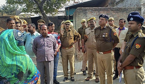 Police personnel investigate at the site where a rape victim was allegedly set ablaze by five men at Sindupur village in Unnao district Thursday Dec. 5 2019. (Photo | PTI)