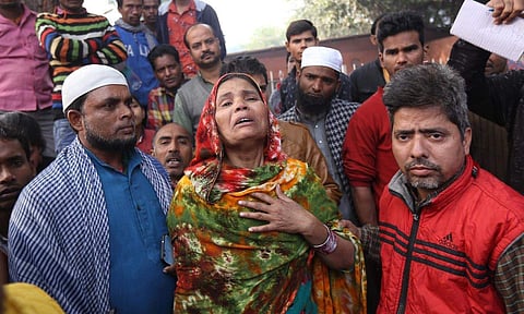 Family members of the Delhi fire deceased wailing at LNJP Hospital. (Photo | Arun Kumar, EPS)
