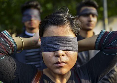 Women blindfold during a protest to highlight the issue of violence against women in the country in New Delhi. (Photo | PTI)