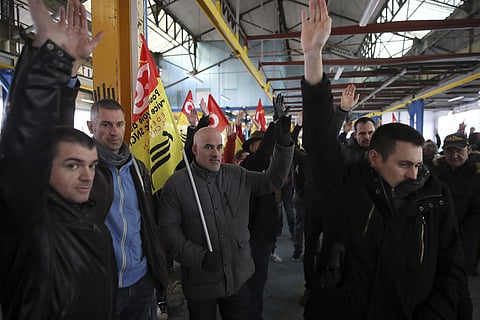 Railway workers gather during a meeting of the CGT and Sud Rail unions in Rennes, western France, Monday, Dec. 9, 2019. Unions launched nationwide strikes and protests over the government's plan to overhaul the retirement system. Paris commuters inched to