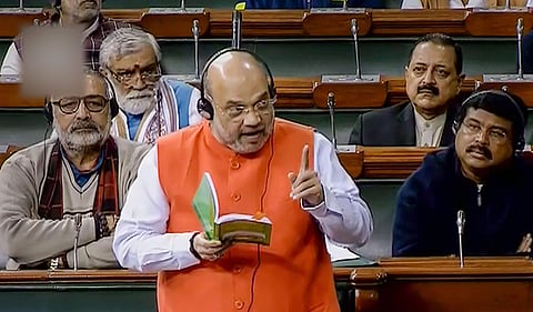Union Home Minister Amit Shah speaks in the Lok Sabha during the ongoing Winter Session of Parliament in New Delhi. (Photo | PTI)