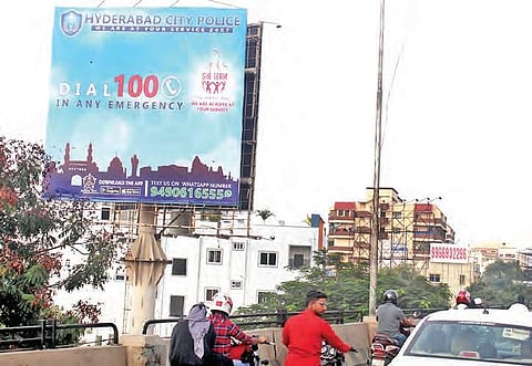 Hoarding by city police seen displaying Dial 100 and other emergency numbers at Masab Tank in Hyderabad | Sathya keerthi