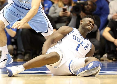 Zion Williamson #1 of the Duke Blue Devils reacts after falling as his shoe breaks against Luke Maye #32 of the North Carolina Tar Heels during their game at Cameron Indoor Stadium in Durham, North Carolina. Nike was in damage control mode on February 21
