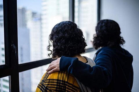 Saudi sisters Rawan (in yellow), 18, and Reem, 20, (both using adopted aliases) stand next to each other during an interview with AFP in Hong Kong on February 22, 2019. (Photo | AFP)