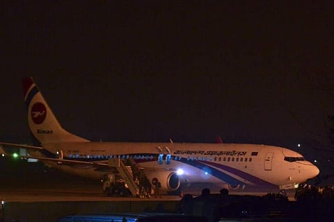 The hijacked Dubai-bound Bangladesh Biman plane is seen at the tarmac after an emergency landing at Chittagong airport. (AFP photo)