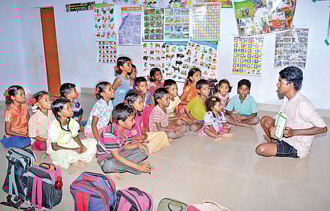 C Jayaraj, an undergraduate student and resident of Samy Nagar dedicatedly teaching children from the community. | Express