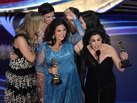 Melissa Berton, center left, and Rayka Zehtabchi accept the award for best documentary short subject for 'Period. End of Sentence.' at the Oscars. (Photo | AP)