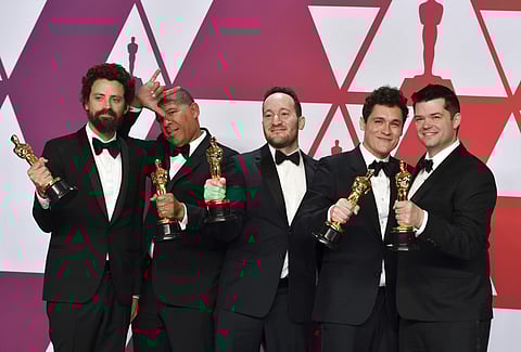 Bob Persichetti, from left, Peter Ramsey, Rodney Rothman, Phil Lord and Christopher Miller pose with the award for best animated feature film for 'Spider-Man: Into the Spider-Verse' at the Oscars. (Photo | AP)