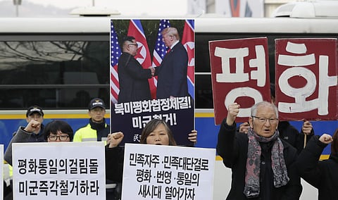 South Korean protesters hold a banner showing a photo of U.S. President Donald Trump and North Korean leader Kim Jong Un during a rally near the U.S. embassy in Seoul, South Korea, Wednesday, Feb. 27, 2019. (Photo | AP)
