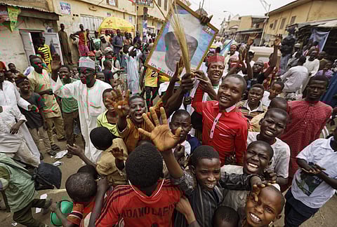 A supporter of Nigeria's President Muhammadu Buhari holds up four fingers to indicate 'four more years', in the streets of Kano, northern Nigeria, Wednesday, Feb. 27, 2019. (Photo | AP)