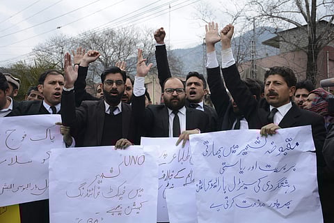 Pakistani Kashmiri lawyers hold banners during a protest in Muzafarabad, capital of Pakistani Kashmir, Tuesday, Feb. 26, 2019. | AP