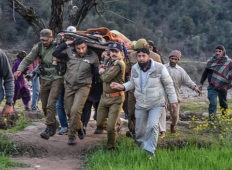 Police officials and locals carry an injured for treatment to a hospital after firing and mortar shelling by the Pakistani Army along the LoC in Krishna Ghati KG sector of J K Thursday Feb. 28 2019. | PTI