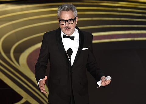 Alfonso Cuaron accepts the award for best director for 'Roma' at the Oscars on Sunday. The film also won the categories of best cinematography and best foreign film. (Photo | AP)