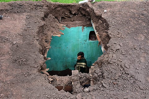 A villager stands inside his damaged house after heavy shelling from the Pakistani side at Mendhar in Poonch district Friday March 01 2019. | PTI
