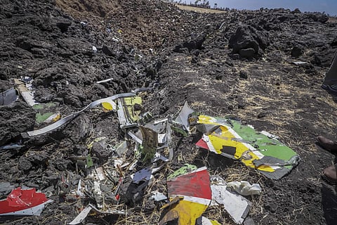 In this image taken from video, rescuers search through wreckage at the scene of an Ethiopian Airlines flight that crashed shortly after takeoff at Hejere near Bishoftu, or Debre Zeit, some 50 kilometers (31 miles) south of Addis Ababa, in Ethiopia Sunday