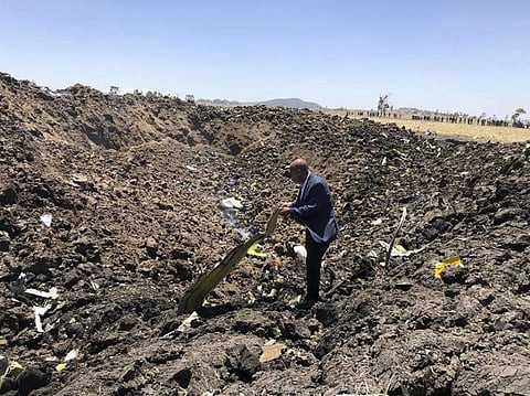 In this photo taken from the Ethiopian Airlines Facebook page, the CEO of Ethiopian Airlines, Tewolde Gebremariam, looks at the wreckage of the plane that crashed shortly after takeoff from Addis Ababa, Ethiopia, Sunday March 10, 2019. | AP