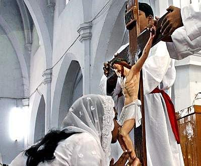A devotee kisses the wounds of the crucified Christ as the part of Good Friday observance (File Photo | EPS)