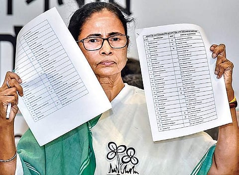 West Bengal Chief Minister and TMC supremo Mamata Banerjee shows the party’s candidates list for upcoming Lok Sabha elections in Kolkata on Tuesday | PTI