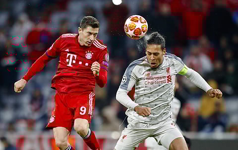 Bayern forward Robert Lewandowski, left, jumps for a header with Liverpool defender Virgil Van Dijk during the Champions League round of 16 second leg soccer match between Bayern Munich and Liverpool in Munich. (Photo | AP)