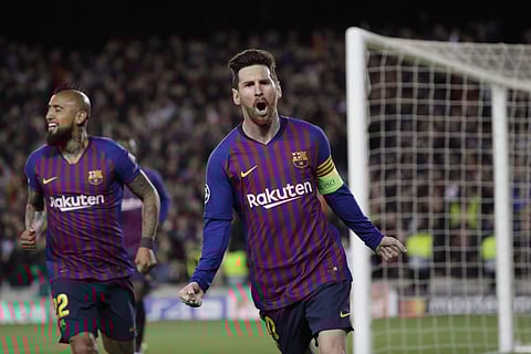 Barcelona's Lionel Messi, right, celebrates after scoring his side's third goal during the Champions League round of 16, 2nd leg, soccer match between FC Barcelona and Olympique Lyon at the Camp Nou stadium in Barcelona. (Photo | AP)