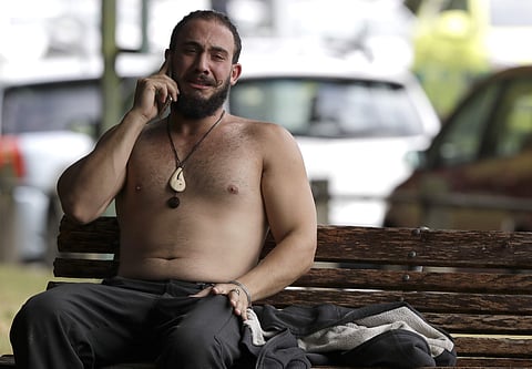 A man reacts as he speaks on a mobile phone outside a mosque in central Christchurch, New Zealand (Photo | AP)