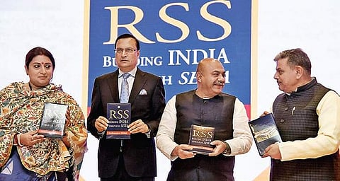 Union Textiles Minister Smriti Irani, journalist Rajat Sharma and RSS joint general secretary Dattatreya Hosabale release a book, ‘RSS : Building India through Sewa’, written by Sudhanshu Mittal (third left) in New Delhi on Friday | parveen negi