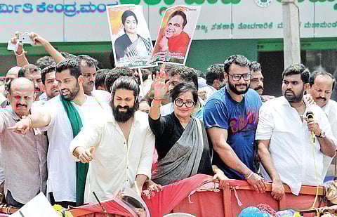 Actors Sumalatha Ambareesh, Darshan and Yash greet a gathering after filing her nomination papers in Mandya on Wednesday; (below) with thousands turning up at the rally, police were forced to lathicharge some | Udayshakar S