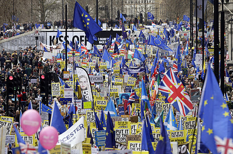 Demonstrators carry posters and flags during a Peoples Vote anti-Brexit march in London. (Photo| AP)