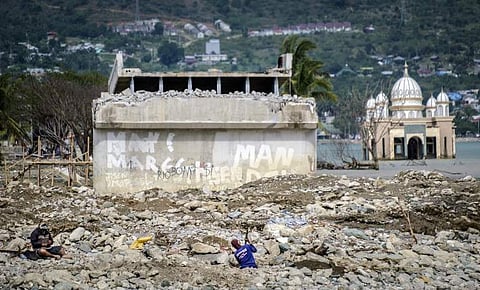 This handout picture taken on March 1, 2019 and released by Save the Children shows a damaged mosque (R) and collapsed Palu bridge in Palu, central Sulawesi. (Photo | AFP)