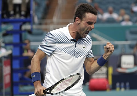 Roberto Bautista Agut, of Spain, reacts after winning a point against Novak Djokovic, of Serbia, during the Miami Open. (Photo | AP)
